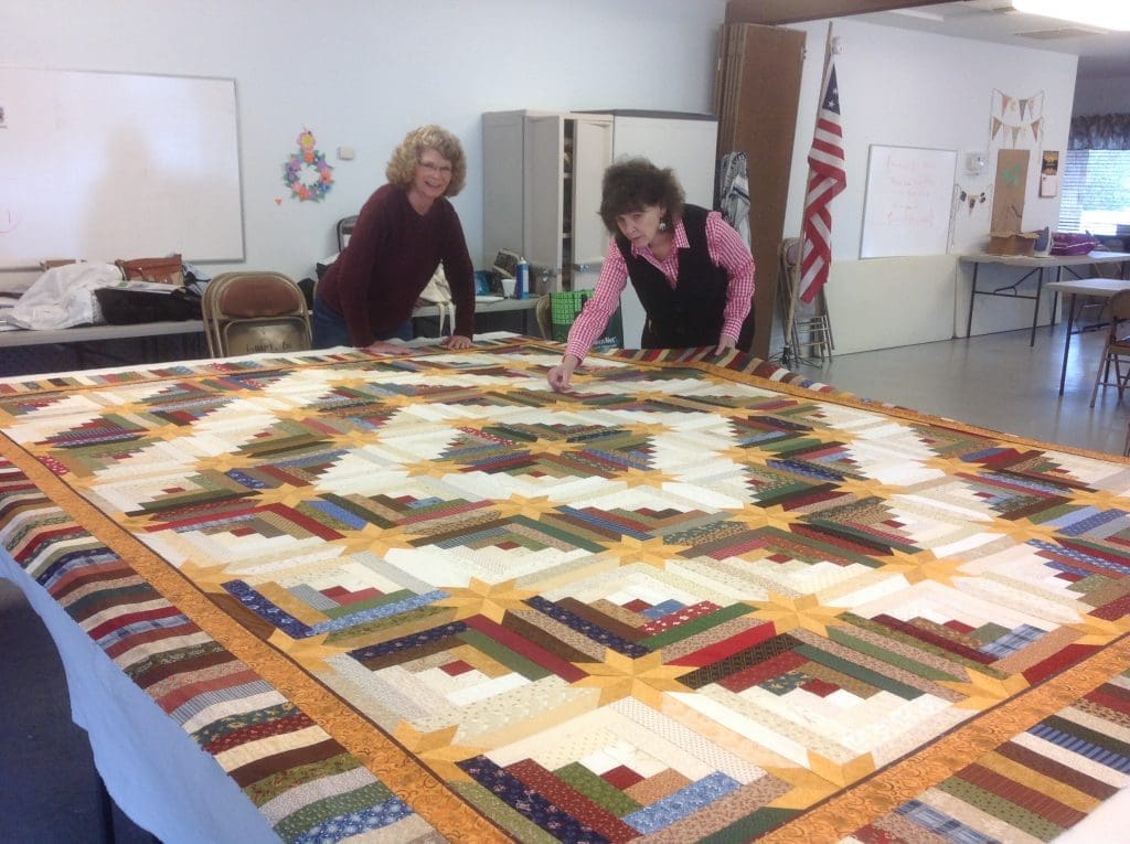 Basting the Star Log Cabin opportunity quilt.