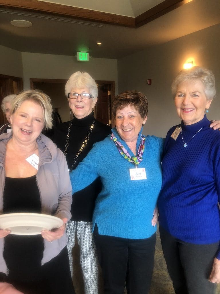 Diane Sproat, Marcia McIntyre, Wilma Hamilton and Ann Grossman share a smile in the buffet line