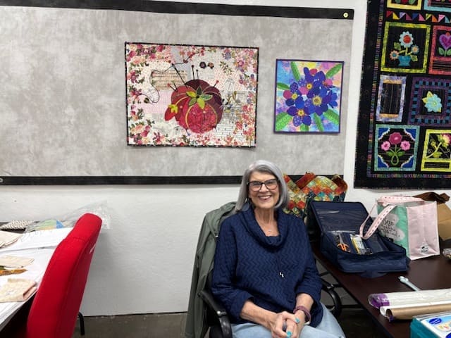 Joyce with a couple of her collage quilts