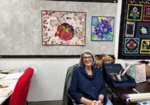 Joyce with a couple of her collage quilts